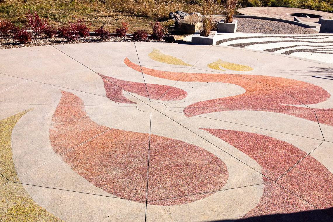 Vibrant aggregate is placed onto the concrete. Decorative Sawcuts on Flatwork - Colorado Hardscapes to add interest.