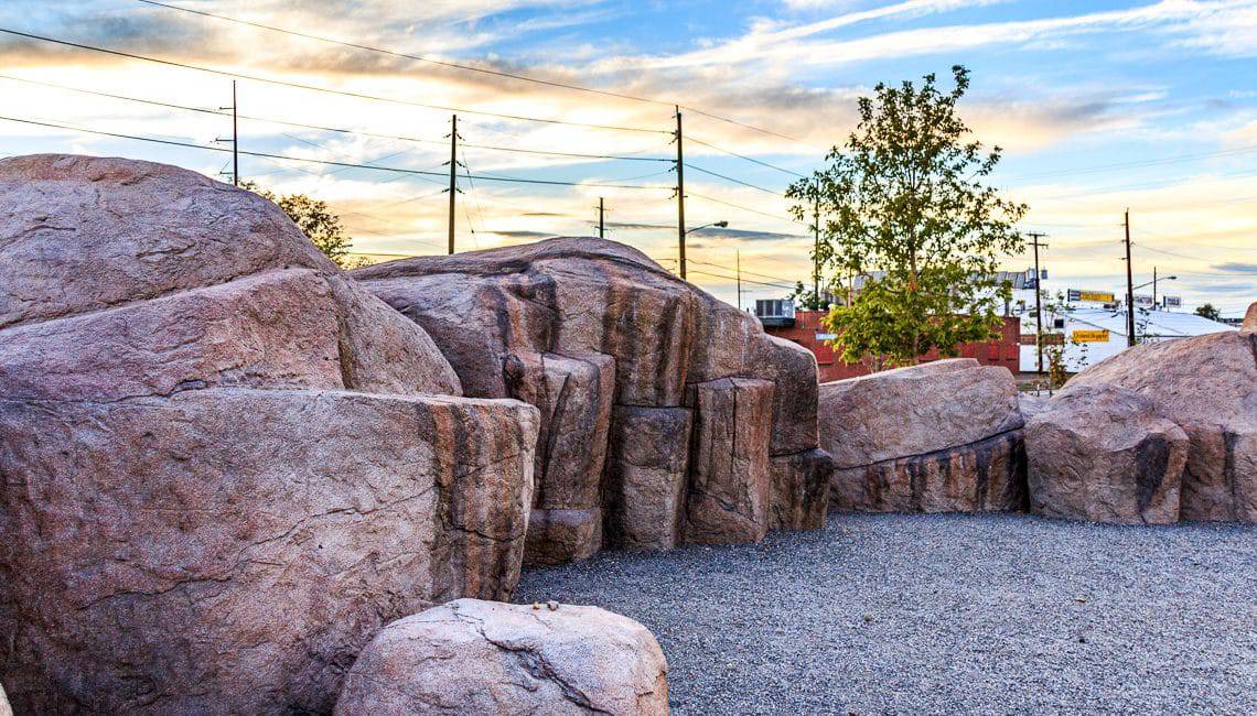 large concrete boulders create a play space in the park