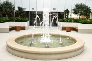 Water feature with concrete basin and nine spray nozzles