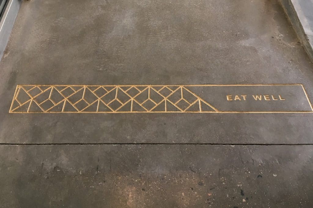 CNC engraved design saying "EAT WELL"