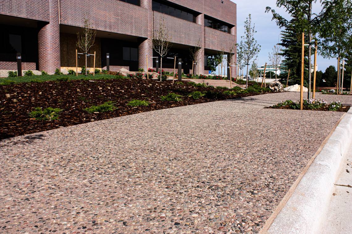 Exposed aggregate flatwork done on exterior pathway at office building.