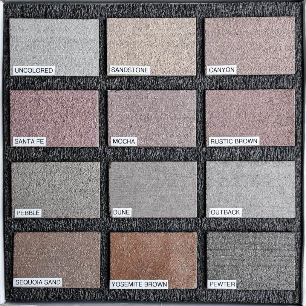 Sample box of twelve color hardener decorative concrete samples with labels from Colordao Hardscapes beautiful pale colors and gray options.