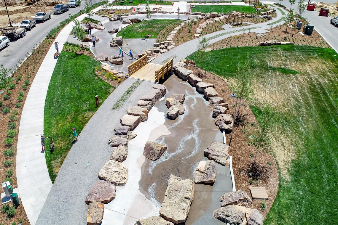 Drone view of strem bed with lithocrete and natural boulders in neighborhood in Colorado.