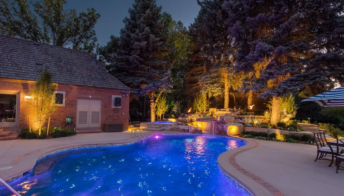 Dream backyard at private residence with sandstone waterfall, spa, and pool with fiber optic lighting.