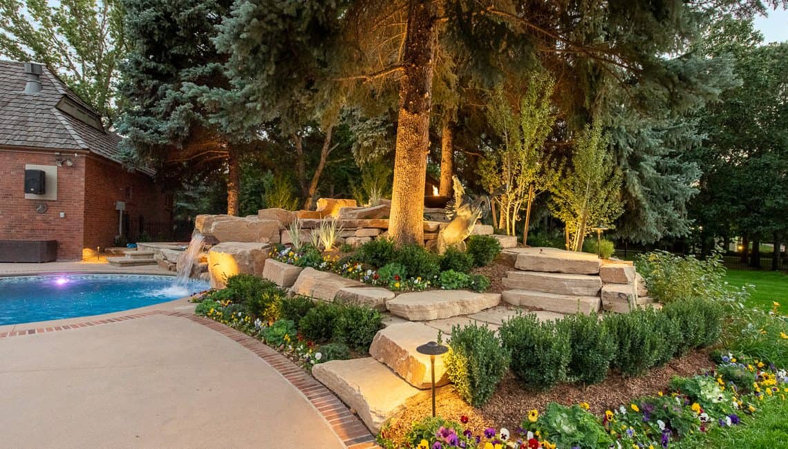 Dream Backyard at private residence with sandstone stepping stones leading to sandstone waterfall.