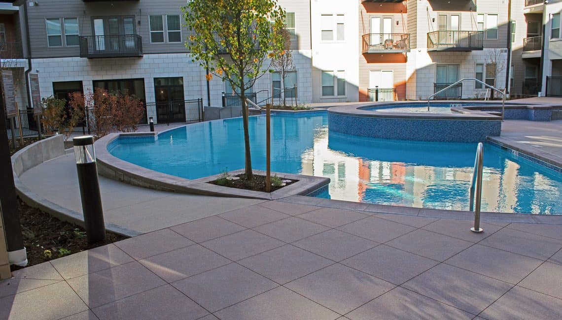 Photo of concrete pool deck and ramp at the Flatiron Marketplace Apartments.